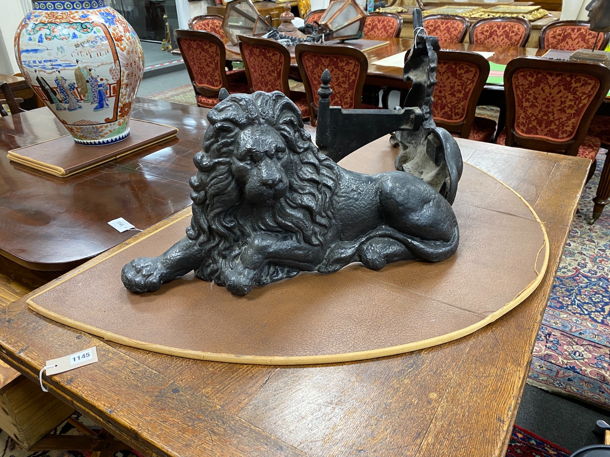 Two cast iron fire ornaments modelled as heraldic lion and unicorn, width 62cm